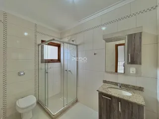 Banheiro com box de vidro e revestimento cerâmico