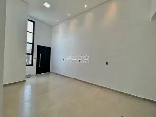 Vista interna de um corredor com paredes brancas e piso de cerâmica.