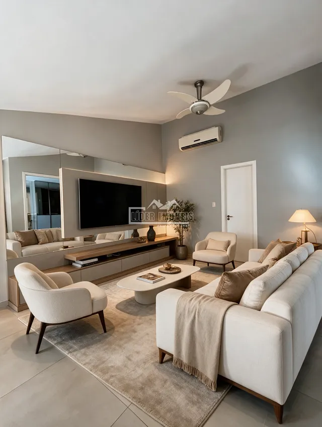 Sala de estar moderna com sofá e poltronas em um ambiente claro.