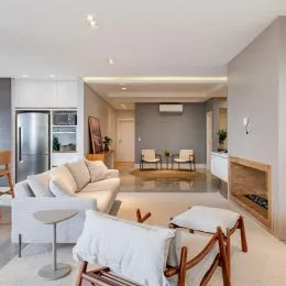 Sala de estar clara com sofá e mesa de centro em um imóvel.