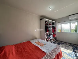 Quarto com cama e guarda-roupa em ambiente interno.