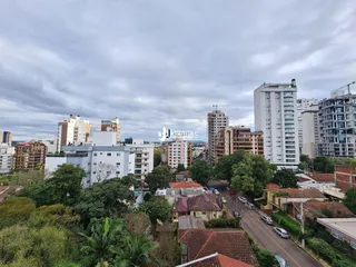 Vista aérea de um bairro residencial em Lajeado, Brasil, mostrando diversas casas e edifícios.