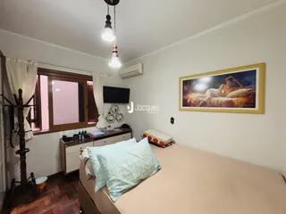 Quarto com cama e janela em ambiente interno.