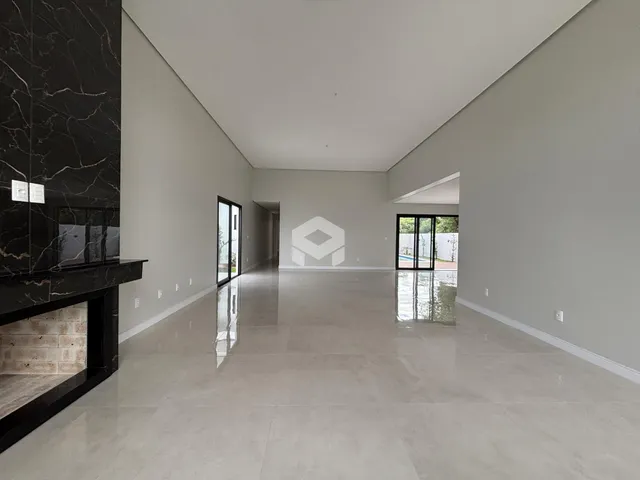 Ambiente interno amplo com piso claro e paredes brancas.