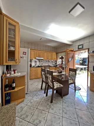 Imagem de uma sala de jantar com cozinha em uma residência.