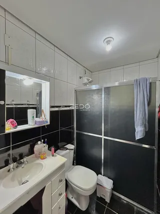 Foto de um banheiro com revestimento de azulejos pretos e brancos.