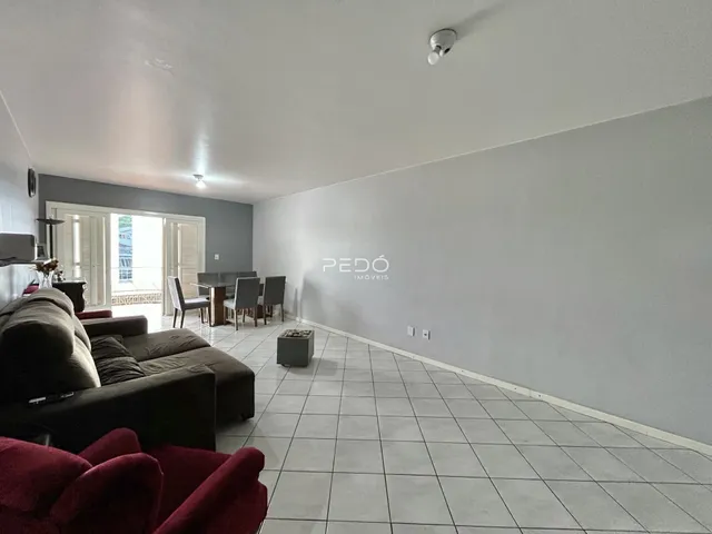 Sala de estar e jantar com piso de cerâmica clara.