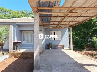 Vista externa de uma casa em Lajeado, Brasil, mostrando uma área coberta com estrutura de madeira.