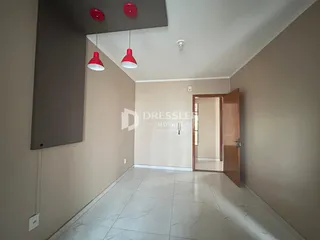 Hall de entrada com piso de cerâmica e paredes em tom neutro.