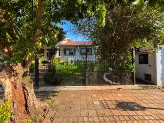 Fachada de uma residência em Lajeado, Brasil, com cerca e vegetação ao redor.