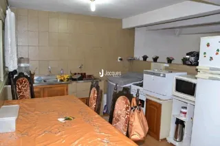Imagem de uma cozinha com armários de madeira e bancadas.
