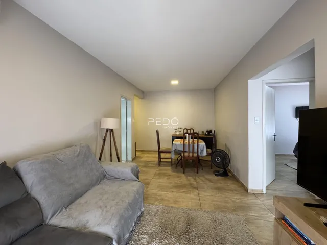 Sala de estar com sofá e mesa de jantar em um imóvel.