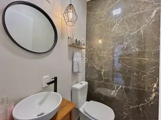 Banheiro moderno com pia e vaso sanitário em um imóvel.