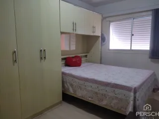 Quarto com cama e armários em um ambiente interno.