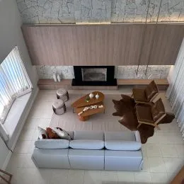 Sala de estar com sofá e lareira em ambiente interno.