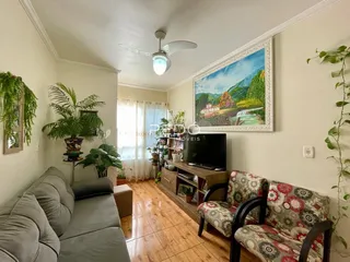 Sala de estar com sofá e decoração em ambiente claro.