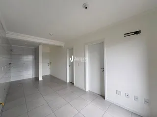 Hall de entrada com piso de cerâmica e portas brancas.