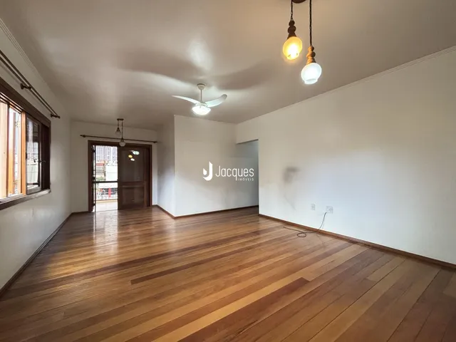 Sala de estar com piso de madeira clara e paredes brancas.