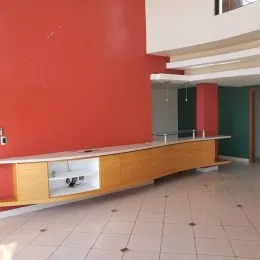 Cozinha com bancada de madeira clara e piso de cerâmica.
