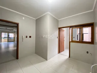 Interior de um corredor com paredes brancas e piso de cerâmica.