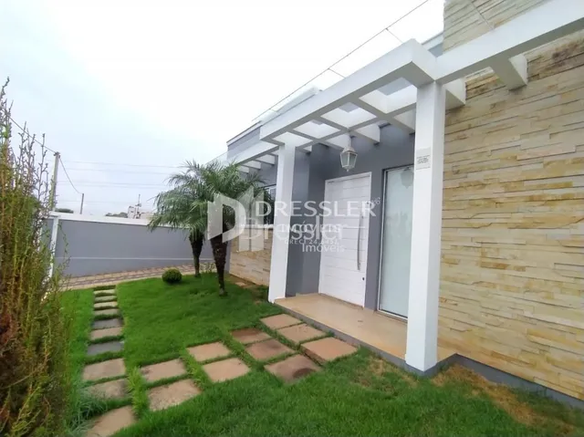 Fachada de uma casa em Lajeado, Brasil com varanda branca e jardim.
