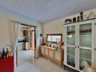 Ambiente de sala de estar com acesso à cozinha em um imóvel no Brasil.