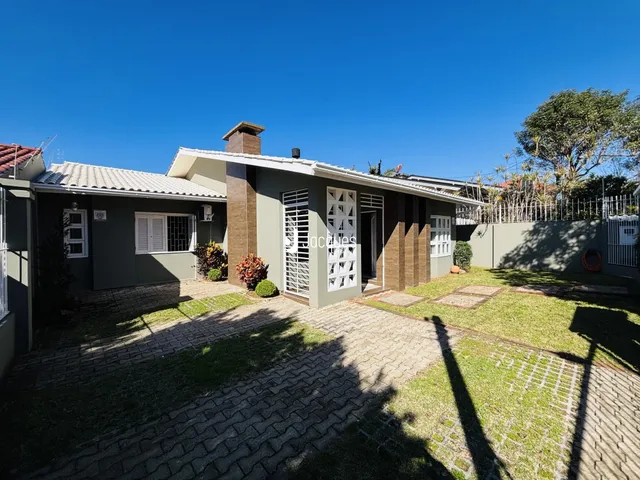 Fachada de uma casa em Lajeado, Brasil, com jardim e área pavimentada.