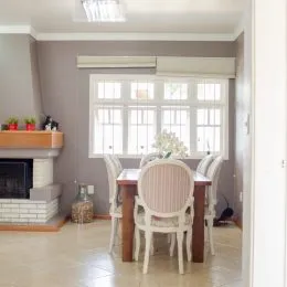 Sala de jantar com mesa e cadeiras em ambiente claro.