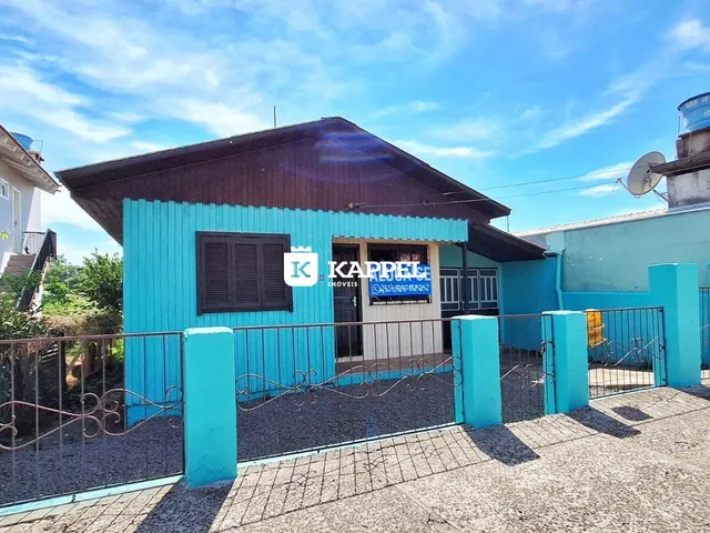Fachada de uma casa azul com cerca em Lajeado, Brasil.
