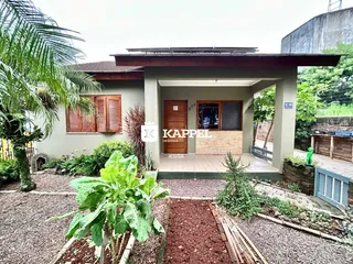 Fachada de uma residência com jardim frontal bem cuidado.