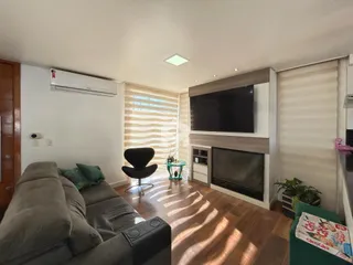 Sala de estar com sofá e lareira em um imóvel no Brasil.