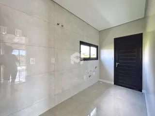Parede interna com revestimento de cerâmica e porta escura.