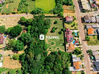 Vista aérea de um terreno com vegetação densa e áreas agrícolas ao redor.