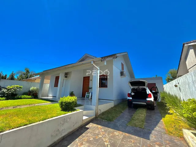 Fachada de uma casa em Lajeado, Brasil, com jardim frontal e área pavimentada.