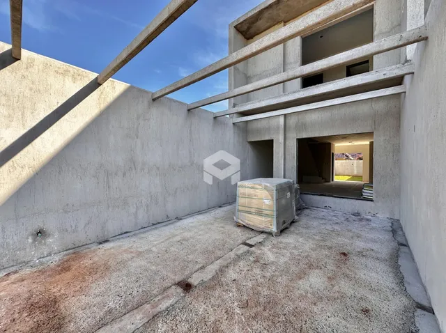 Vista externa de uma estrutura de concreto em construção.
