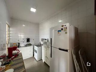 Interior da cozinha com revestimento de azulejos brancos.