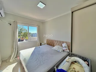Quarto com janela e cortinas em uma residência.