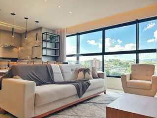 Sala de estar moderna com grande janela de vista para a paisagem.