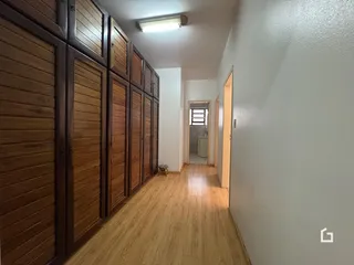 Hall de entrada com piso de madeira e armários embutidos.
