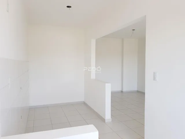 Hall de entrada com piso de cerâmica clara em imóvel no Brasil.
