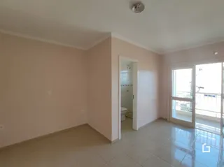 Vista interna de um cômodo com paredes brancas e piso de cerâmica.