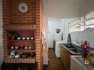 Vista interna de uma cozinha com parede de tijolos aparentes.