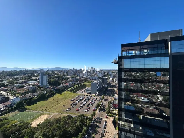 Vista aérea de uma área residencial com paisagem urbana e campos verdes.