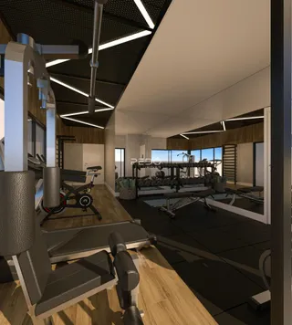 Ambiente amplo de academia com piso de madeira e equipamentos de ginástica.