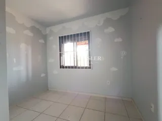 Foto de uma sala com piso de cerâmica e janela com grade.