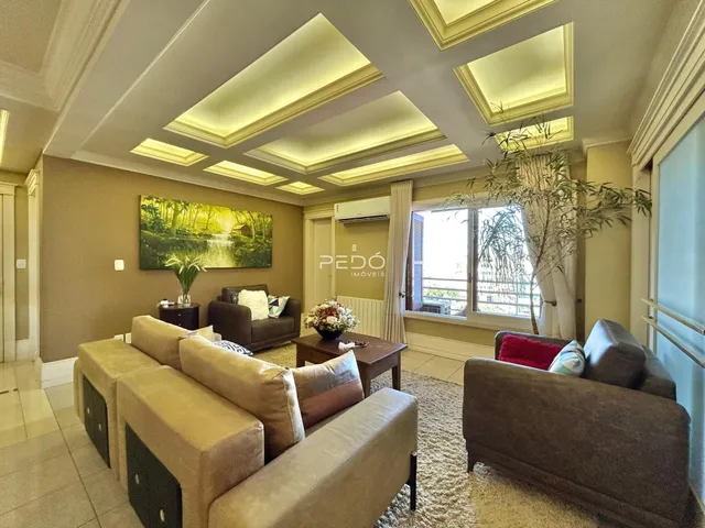 Sala de estar com teto em caixão e grandes janelas.