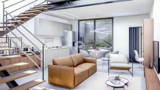 Sala de estar moderna com cozinha aberta e vista para o jardim.