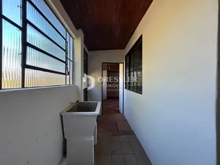 Hall de entrada com janela e teto de madeira em imóvel no Brasil.
