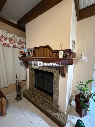 Foto de uma lareira com revestimento de madeira em um ambiente interno.