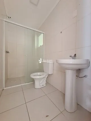 Foto de um banheiro interno com revestimento branco.